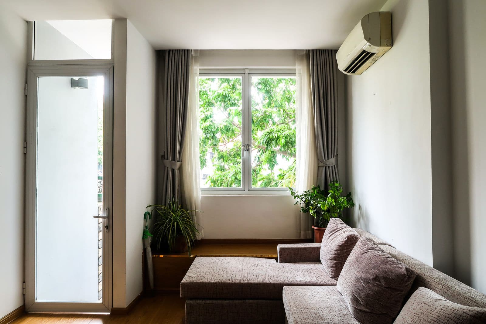 A clean white wall-mounted ductless mini-split air conditioner inside a home