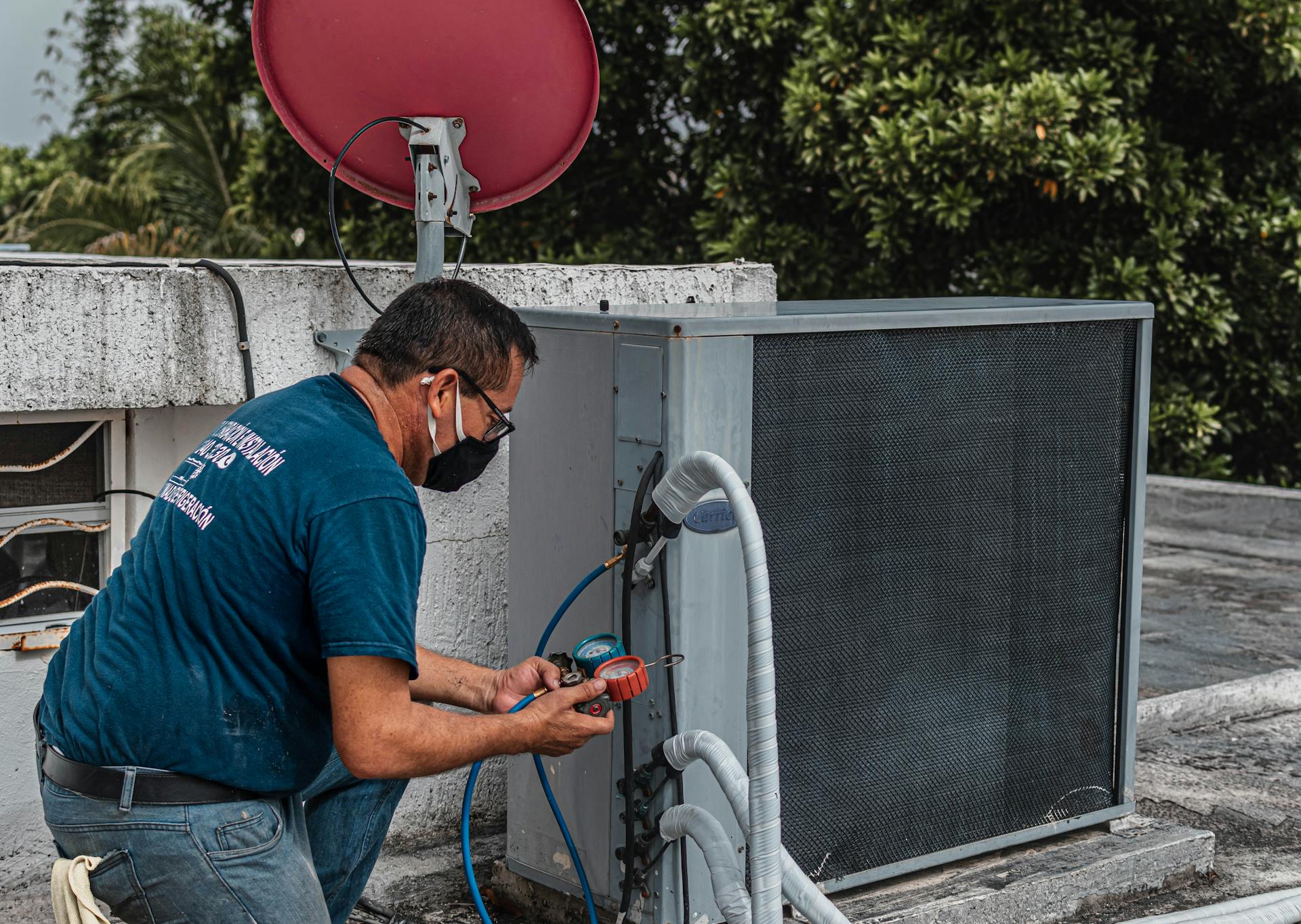 The AC Boys technician servicing an air conditioning condenser unit in South Florida